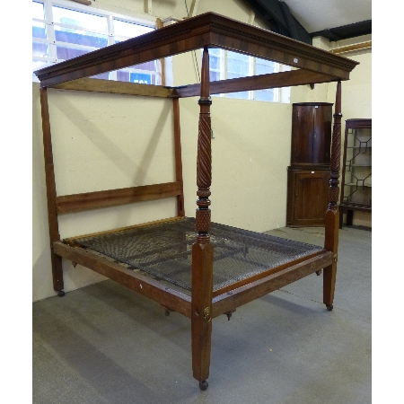 A mahogany four poster double bed