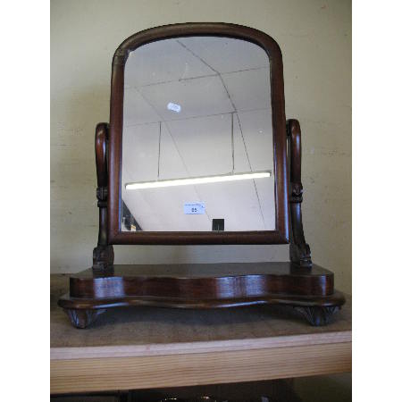 A mahogany swing mirror
