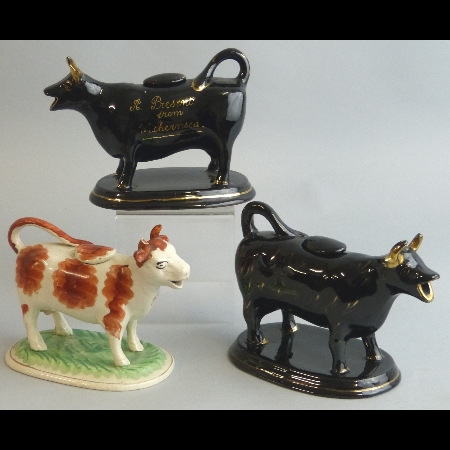 A pair of late 19th Century cow creamers