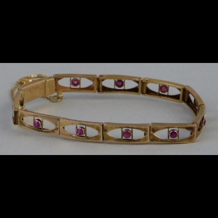 A continental yellow metal and ruby bracelet