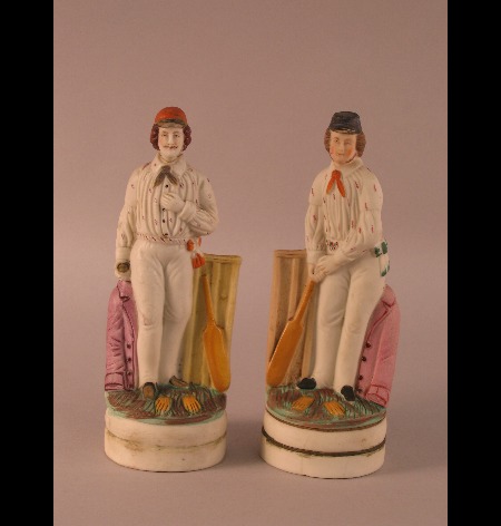 A pair of early 20th Century coloured bisque figures of cricketers