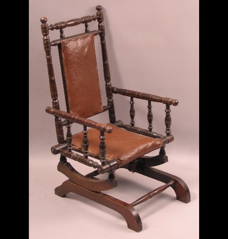 A child's Victorian stained beech rocking chair
